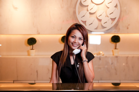 BANGKOK, THAILAND - APRIL 29 : receptionist answer the phone at  the "dream " hotel an upscale hotel  on April 29, 2009 in Bangkok, Thailandのeditorial素材