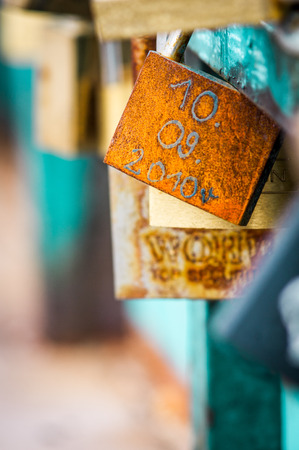 Symbolic love padlocks fixed to the railings of grunwaldzki  bridge, Wroclaw, Poland. Shallow depth...