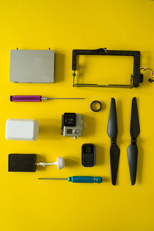 Top view of drone components, included propellers, video link, digital transmitter and screwdriver ...