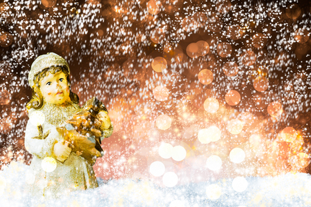Christmas tree decoration on snow, against a beautiful holiday inspired background, snow effect added, copy space leftの写真素材
