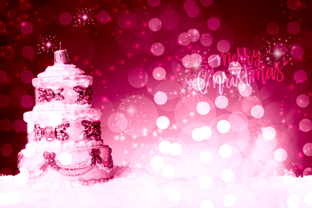 Christmas tree decoration with the shape of a multi floor cake,  on snow, against a beautiful holiday inspired background, pinkish tonality copy space leftの写真素材