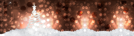 Christmas tree decoration on snow, against a beautiful holiday inspired background, poster format, copy space leftの写真素材