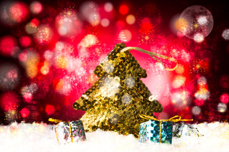 Christmas treee made with golden paillettes and some decorative gift holiday composition, beautiful background to add text.の写真素材
