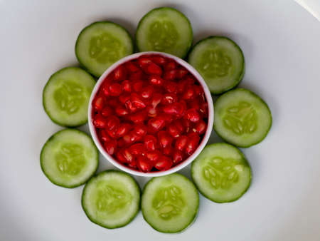 Fresh sliced cucumber and pomegranate kernels- organic healthy vegetables and fruits