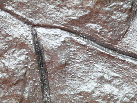 Old stone wall with metallic silver paint as texture, background