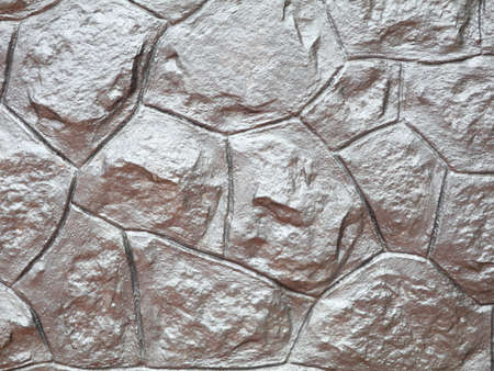 Old stone wall with metallic silver paint as texture, background