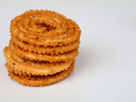Nurukku or murukku ,a tasty and crunchy traditional Kerala snack made of rice powder in white...