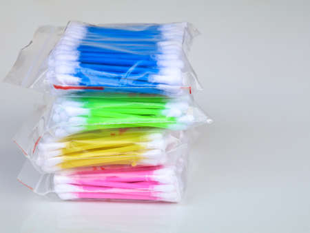 Multi colored ear cleaning buds in packets, against white background, isolated