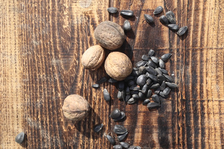 Walnuts and sunflower seeds on a wooden background. Selective focus.の写真素材