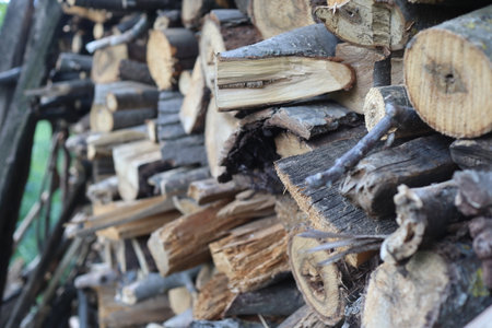 Firewood stacked in a pile on a wooden background. Selective focus.の写真素材