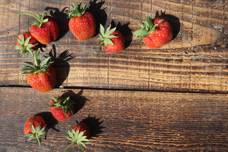 Strawberries on a wooden background. Top view, copy spaceの写真素材