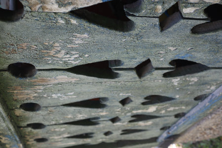 Old wooden planks with holes in the form of an arrow.