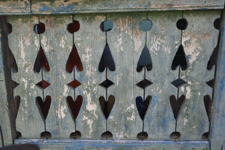 Wooden door with holes in the form of hearts, closeup of photoの写真素材