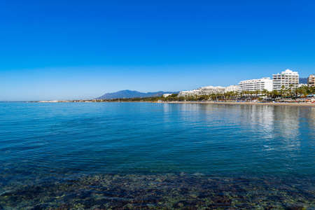 Scenic Mediterranean view from the beach - Marbella, Spain with hotels in the distanceの写真素材