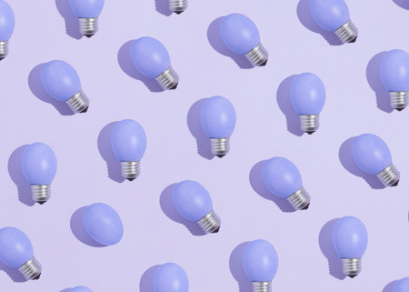 Minimal pattern concept with bulbs made of delicate pale blue Easter eggs isolated on pastel blue background. Creative aesthetic Easter festive texture idea. Minimal flat lay.の写真素材