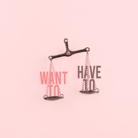 Words "want to" and "have to" on a copper scales on an isolated pastel coral pink background. Concept of motivation. Minimal 3D abstract creative illustration. Pop psychology card.の写真素材