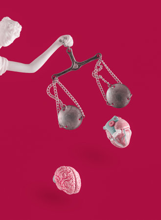Pastel white Lady Justice with human heart and brain falling out of scales on isolated red background. Abstract concept of law, anger, unfairness. Symbol of justice or unfairness.の写真素材
