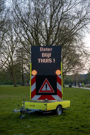 Rotterdam, the Netherlands - April 12 2020: sign in a city park of Rotterdam to warn people to keep your distance and stay at homeのeditorial素材