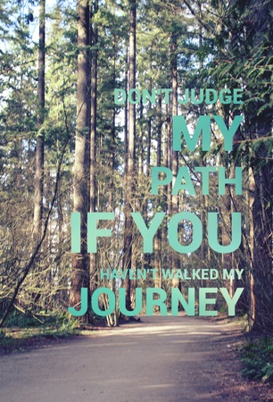 Conceptual image with large green font on blurred background of path through tall forest trees.の写真素材