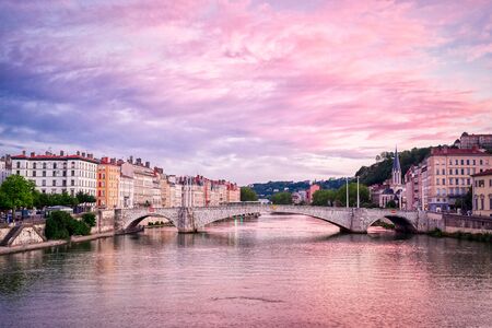 A view of Lyon, France along the SaÃ´ne river at sunset.の写真素材