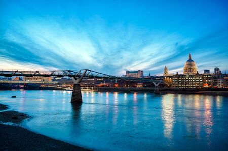 St. Paul's Cathedral across Millennium Bridge and the River Thames in London, UK.の写真素材