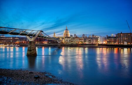 St. Paul's Cathedral across Millennium Bridge and the River Thames in London, UK.の写真素材