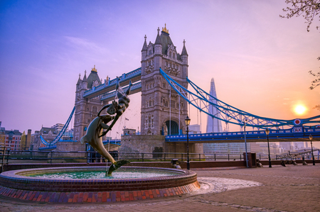 London, United Kingdom - April 17, 2019 : View of Tower Bridge on the River Thames with the Girl with Dolphin fountain, created by David Wynne in 1973.のeditorial素材