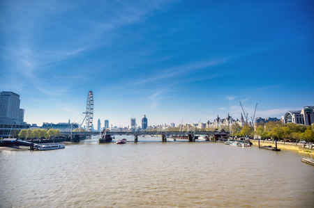 A view along the River Thames on a sunny day in London, UK.のeditorial素材