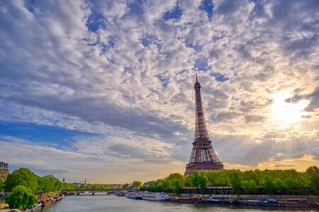 The Eiffel Tower across the Seine River in Paris, France on a sunny day with beautiful clouds.の写真素材
