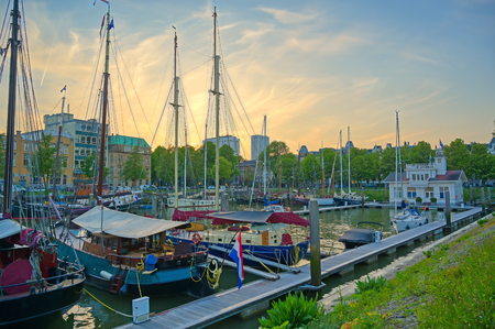 Ships docked along the canals in Rotterdam, Netherlands at sunset.のeditorial素材
