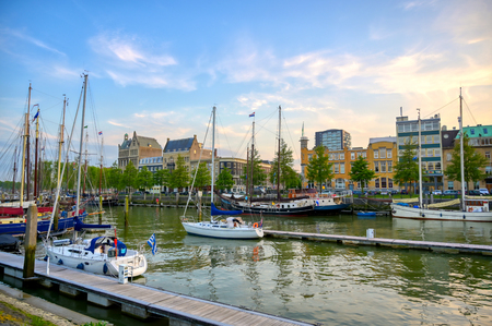 Ships docked along the canals in Rotterdam, Netherlands at sunset.のeditorial素材