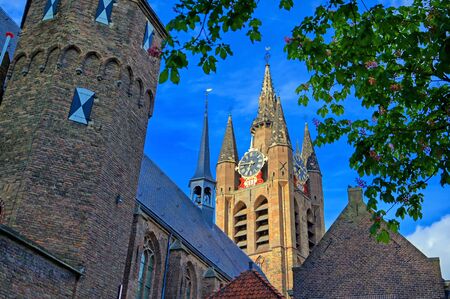 The Oude Kerk (old church) in the city of Delft in The Netherlands on a sunny day.の写真素材