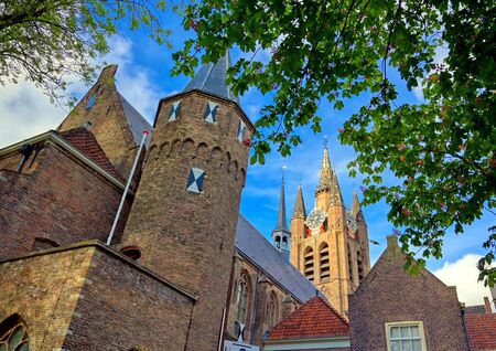 The Oude Kerk (old church) in the city of Delft in The Netherlands on a sunny day.の写真素材