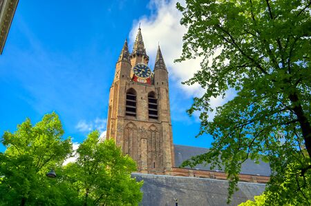 The Oude Kerk (old church) in the city of Delft in The Netherlands on a sunny day.の写真素材