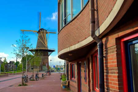 A windmill in the city of Delft in The Netherlands on a sunny day.の写真素材