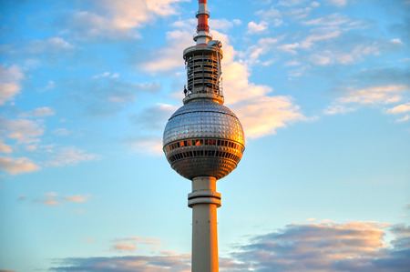 A view of the television tower (Fernsehturm) over the city of Berlin, Germany at sunset.のeditorial素材