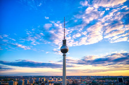 A view of the television tower (Fernsehturm) over the city of Berlin, Germany at sunset.のeditorial素材
