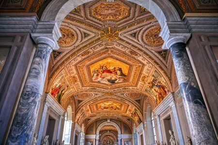 Vatican City, Vatican - May 31, 2019 - Paintings on the walls and the ceiling in the Vatican Museum,...