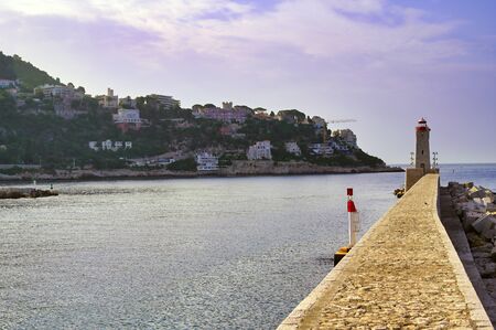The lighthouse at the Port of Nice on the Mediterranean Sea at Nice, France along the French Riviera.の写真素材
