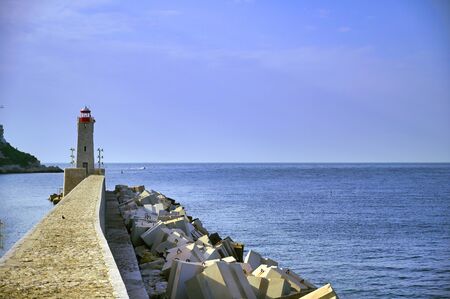 The lighthouse at the Port of Nice on the Mediterranean Sea at Nice, France along the French Riviera.の写真素材
