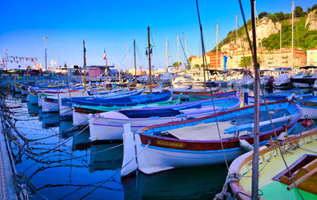 Nice, France - June 08, 2019 - Fishing boats docked in the port along the French Riviera on the Mediterranean Sea at Nice, France.のeditorial素材