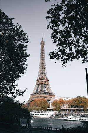 The Eiffel Tower in Paris, France during autumn with warm seasonal tones and soft natural light....