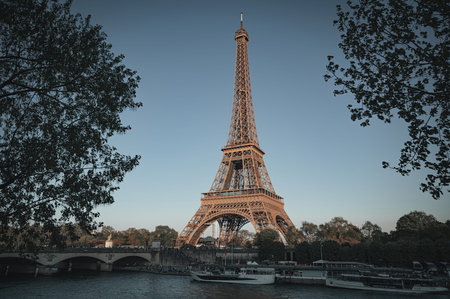 The Eiffel Tower in Paris, France during autumn with warm seasonal tones and soft natural light....