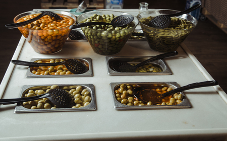 Self-service of olive snacks in storeの写真素材