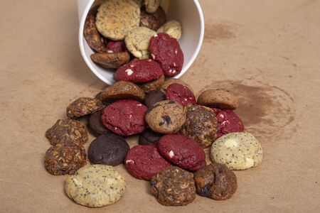 Assortment of mini cookies of various flavors on paper background
