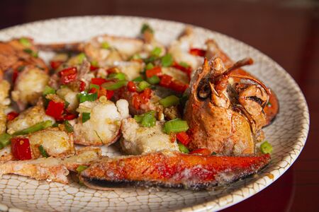 Lobster dish with salt and pepper served on a porcelain plate. Isolated image.の写真素材