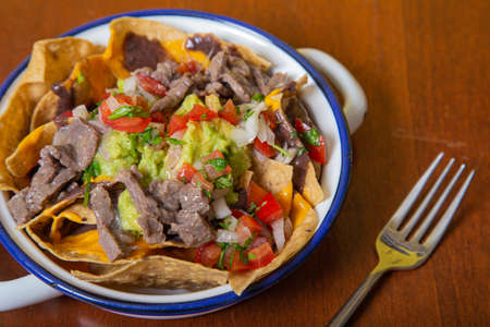 Traditional Mexican nachos with beef steak and guacamole.の写真素材