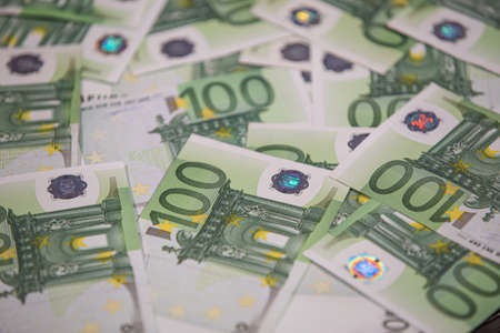 Background text of one hundred euro bills. Selective focus.
