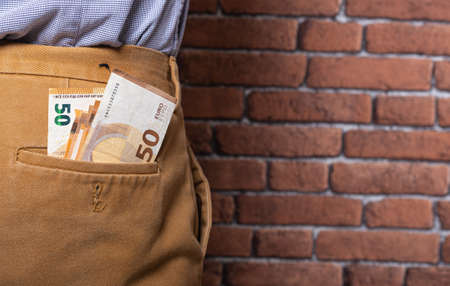 There are a lot of bills in the back pocket of my pants.の写真素材