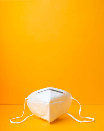 Respiratory or surgical face mask. or protection on yellow background. Pandemic or epidemic concept.の写真素材